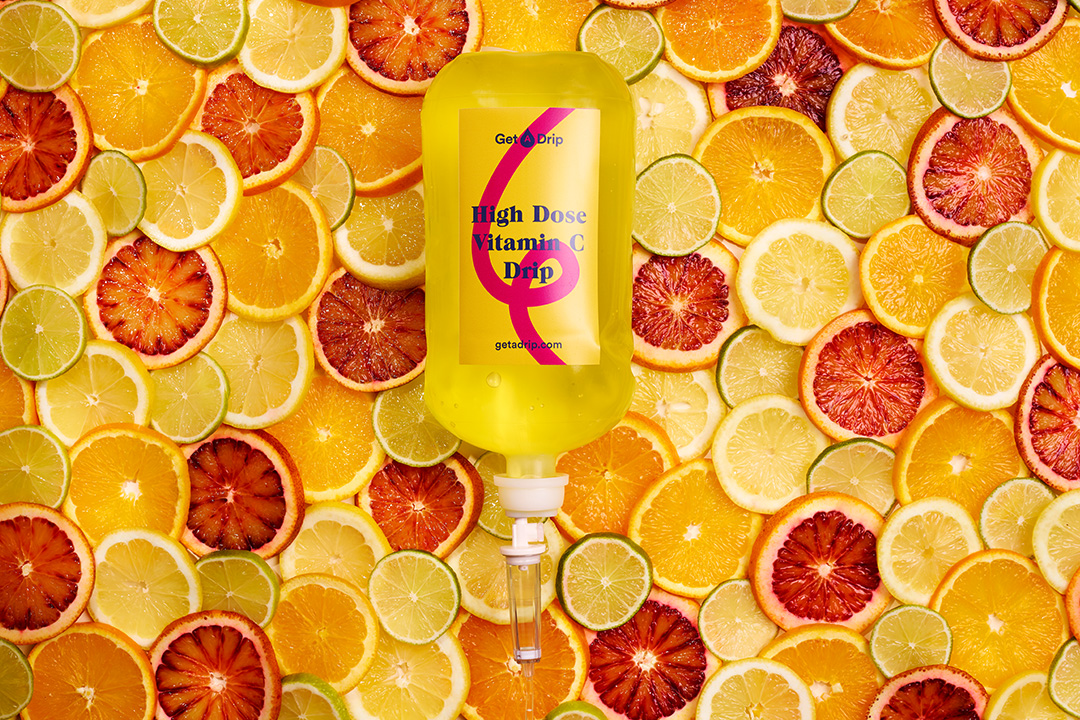 Vitamin C drip surrounded by oranges