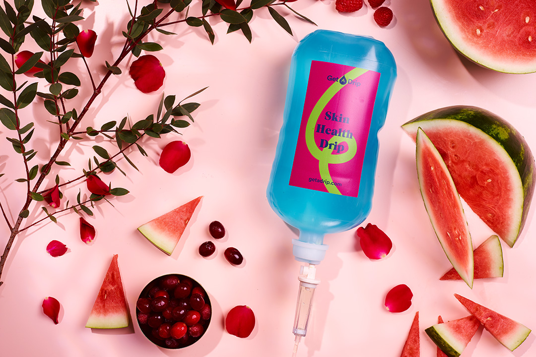 Skin health vitamin drip surrounded by red fruits