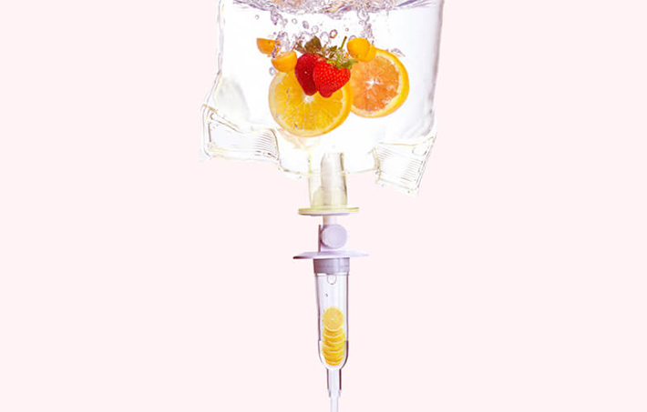 All in One Jet Fuel Drip Double detox vitamin drip surrounded by fruit, vegetables and ingredients